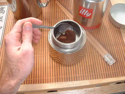 Add ground espresso to moka pot espresso maker