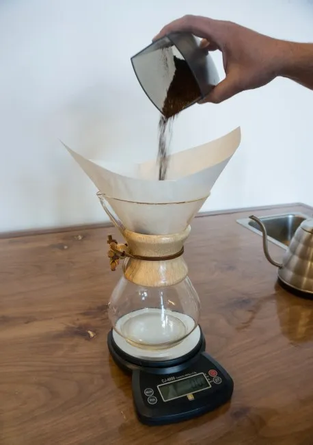 add ground coffee inside chemex coffee fitler