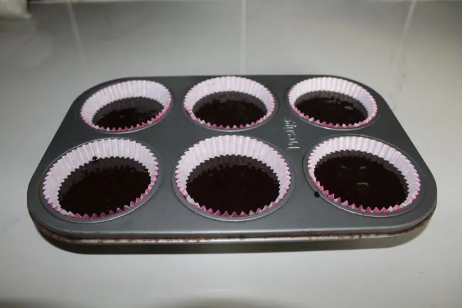 put cupcake tray into oven
